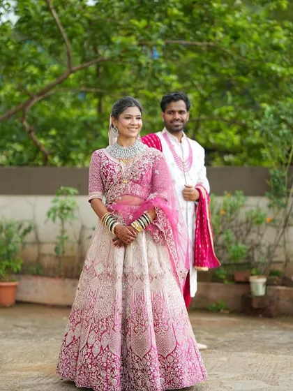 Your portfolio can also include couple shots to show how your makeup work fits into a complete wedding scene. Here is the same pink lehenga styled for a pre-wedding or wedding day shoot.