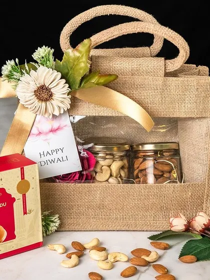 Our eco-friendly and stylish jute bags are a popular choice for corporate gifting. This Diwali gift set features a box of traditional motichoor ladoo and jars of premium nuts, beautifully arranged in a reusable windowed jute bag. It’s a tasteful and sustainable gifting option.