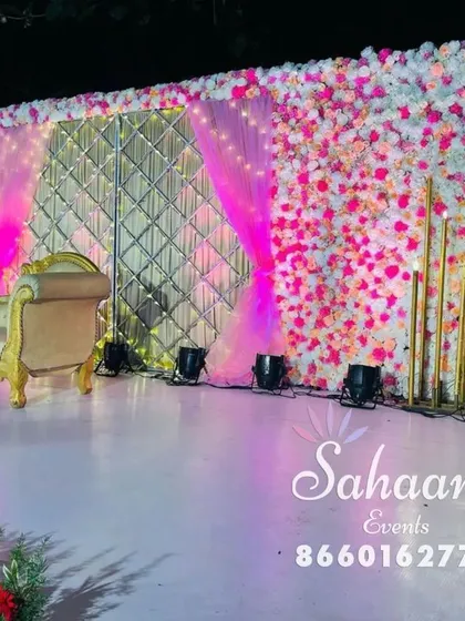 A popular choice for engagements and receptions, this stage combines a glamorous quilted gold backdrop with soft pink draping and a custom neon sign. It’s a modern, chic, and highly photogenic setup for any celebration of love.
