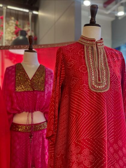 Bright red and pink bandhani-print outfits by Punit Balana, featuring a crop top and skirt set and a high-neck kurta.