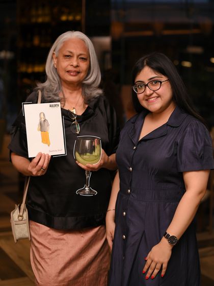 A happy guest holding her personalized illustration. Our events are about creating joyful, multi-sensory experiences that go beyond just viewing jewelry.
