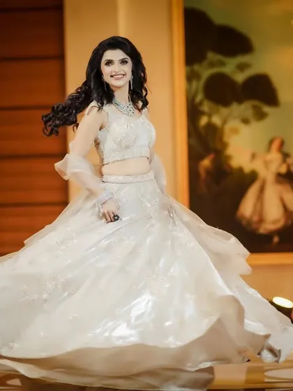 A joyful twirling shot of the bride in her reception gown.