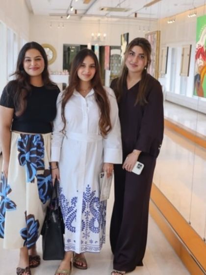 Guests enjoying the art and atmosphere at the 'A Symphony of Colour' exhibition.