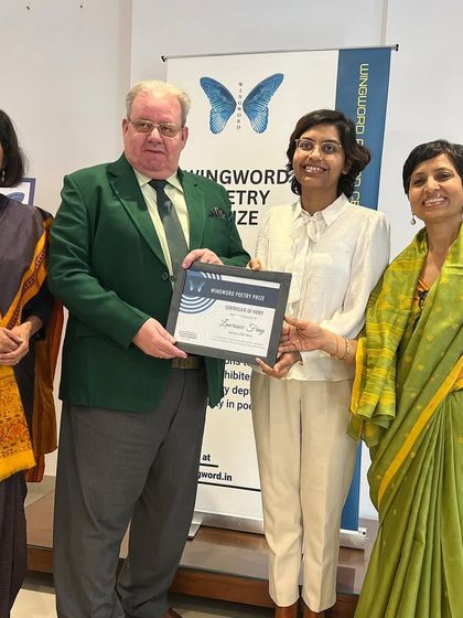 Winner Lawrence Fray receives his award from the guests of honour.