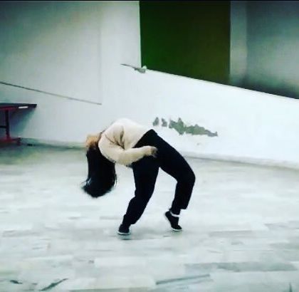 A shot of a backbend, a move that requires both strength and flexibility. I am always working on improving my technique.