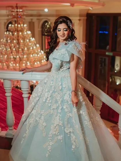 This bride looks like a princess in her powder blue gown. The makeup features shimmering blue eyes and a subtle brown lip.