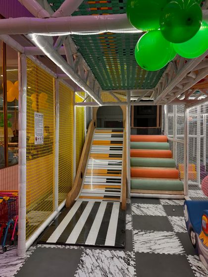 A look at our multi-level play structure, featuring slides and stairs for endless exploration and adventure.