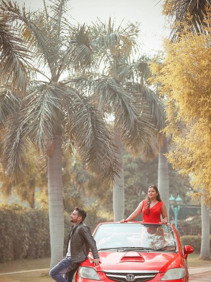 A creative and fun shot with a red convertible, capturing the couple's playful spirit during their pre-wedding shoot.