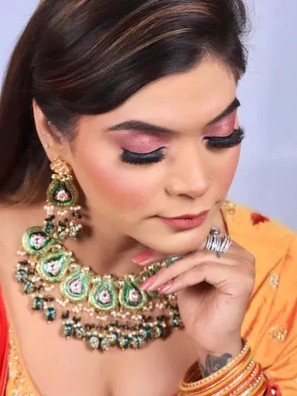 This angle shows the beautiful shimmer on the eyelids and the dramatic false lashes that make the eyes the focal point of this party makeup look.