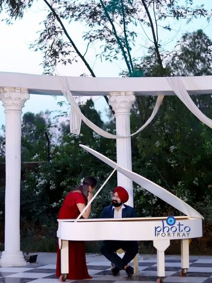 A romantic and interactive shot with the couple at the white piano. This pose feels more intimate and tells a story within the grand setting.