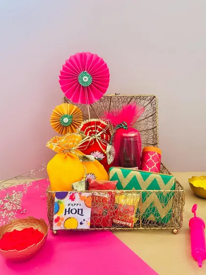 A closer look at my vibrant Holi hamper in a gold wire box. The mix of colors, textures, and treats makes it a truly joyful and exciting gift to receive.