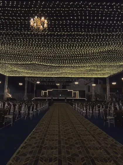 The full view of a 'Starry Night' sangeet setup. I used a massive canopy of fairy lights over the entire guest seating area to create an immersive experience of dining and celebrating under the stars.