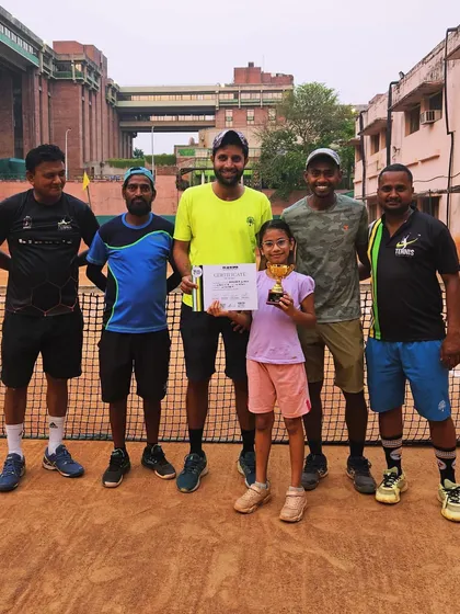 Our coaching team with another young winner. We are proud of all our players.