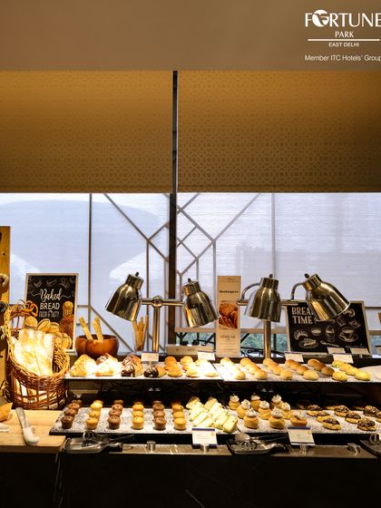 Our "Bread Time" station at the breakfast buffet, featuring an assortment of freshly baked breads, muffins, pastries, and cookies under warm heat lamps.