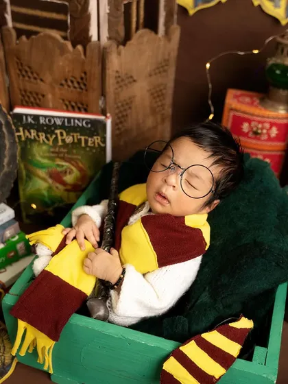A close-up of our sleeping wizard, showcasing the detailed props like the Harry Potter book and potion bottles that make this theme so special.