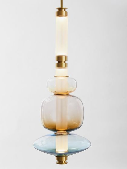 A studio shot of a Luna pendant, highlighting its perfectly balanced composition of colored glass and illuminated tubes.