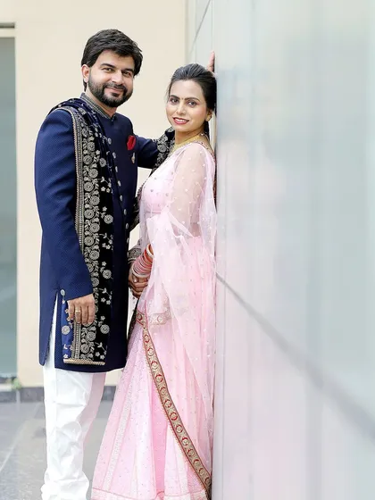 A modern and stylish pose against a clean architectural background. Pre-wedding shoots are a great chance to experiment with different looks and locations.