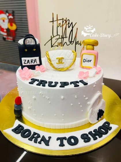 A 'Born to Shop' cake for the ultimate shopaholic. This design is topped with edible, handcrafted miniatures of shopping bags from brands like Zara and Chanel, and a Dior perfume bottle.