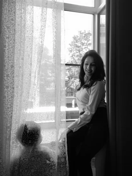 A black and white photo capturing a quiet moment between my son and me. This image beautifully shows the connection across generations, a mother and child sharing a simple, peaceful moment by the window.