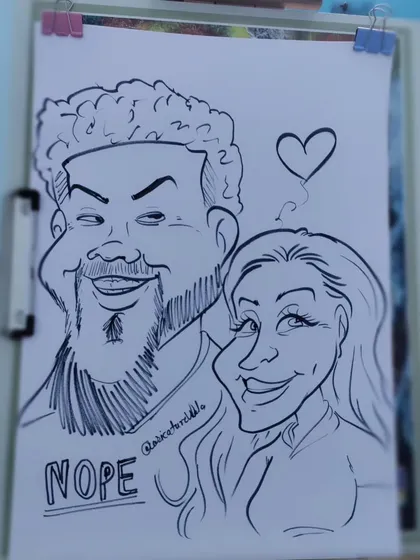 A playful "Nope" shirt adds a bit of humor to this couple's caricature. I love incorporating personal details like this.