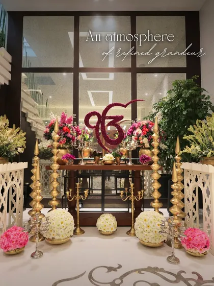For this sacred event, we created a stunning focal point with a floral 'Ek Onkar' symbol. The setup is framed by traditional brass lamps and beautiful floral arrangements, creating an atmosphere of refined grandeur.