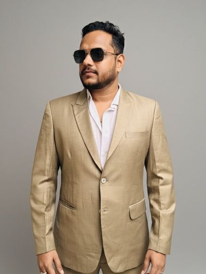 A simple and elegant beige blazer that is perfect for daytime events. The light color and clean design make it a great rental for a summer wedding or outdoor party.