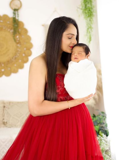 A mother's gentle kiss for her sleeping baby, a timeless expression of love.