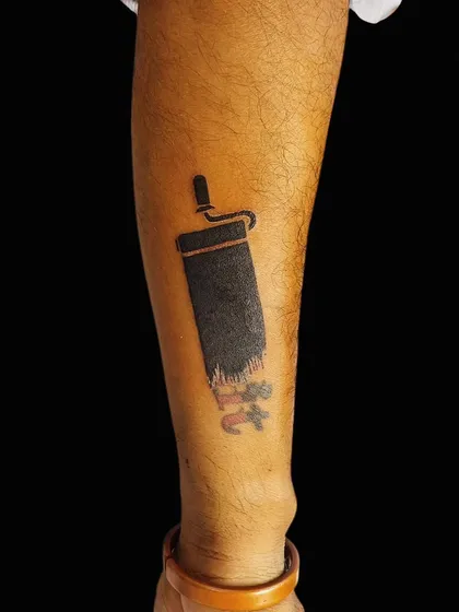 For a client who wanted a fun and creative way to hide an old tattoo, we designed this unique paint roller concept. The solid black ink effectively "paints" over the old design, making for a clever and memorable arm tattoo.