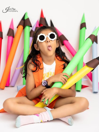 Sticking her tongue out, this photo is all about capturing that cheeky, fun-loving spirit of childhood.