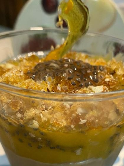A close-up of our passionfruit and chia seed pudding. This healthy yet delicious dessert is layered in a glass, showcasing its beautiful textures and colors.