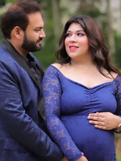A close-up shot of a couple, with the mom-to-be wearing a beautiful blue lace bodycon gown. The long sleeves and intricate texture of the lace add a touch of classic romance.
