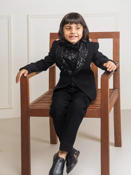 Another view of the black tuxedo with the sparkling sequin cowl neck. This design is a great option for a boy's birthday party or a New Year's Eve event.