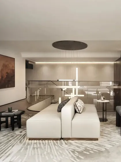 This angle showcases the comfortable, modern sofa and abstract area rug that adds texture to the space. The layout is designed to facilitate conversation and relaxation, making it a perfect family gathering spot.