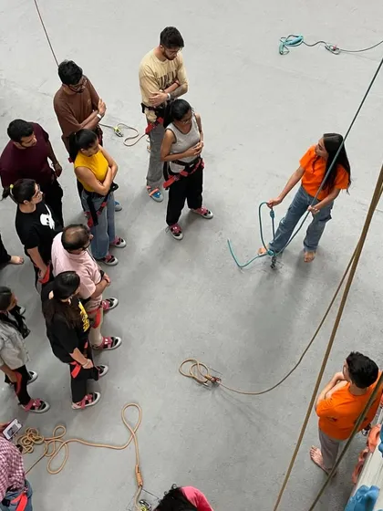 A group of new climbers gets a safety briefing. This essential 15-minute introduction covers everything you need to know to climb safely and confidently.