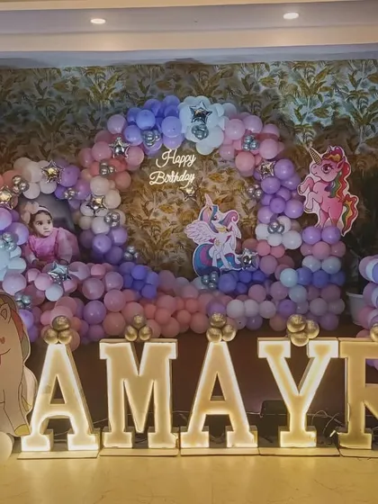 A 'My Little Pony' and unicorn theme for Aamyra's first birthday. The pastel balloon arch and large light-up letters create a dreamy photo corner.