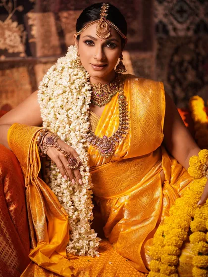 A powerful and regal pose. Tanishaa's direct gaze and confident posture, combined with the opulent saree and jewelry, create an image of a modern-day maharani.