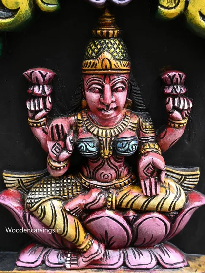 A close-up of one of the goddesses from the 72-inch vertical AshtaLakshmi panel. The vibrant painting on a dark background makes the figure's details pop with color and life.