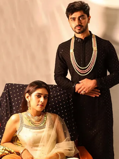 Here is another angle of our stunning couple, showcasing her detachable Polki and emerald necklace and his layered Polki piece with emerald and rose quartz.