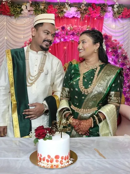 We love capturing the candid moments of joy. This couple shares a happy look over their custom engagement cake, decorated with fresh red roses.