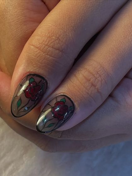 A close-up of our stained-glass rose nail art. You can see the detail in the petals and leaves, all encapsulated in a glossy, transparent nail for a unique and artistic finish.