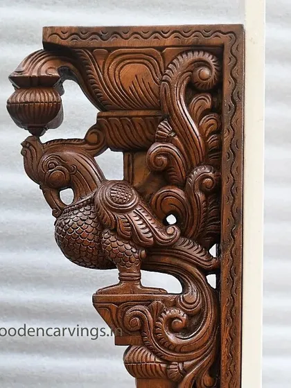 Another angle of the Annapakshi bracket, showing the graceful curve of its neck and the detailed scrollwork that forms the support structure.