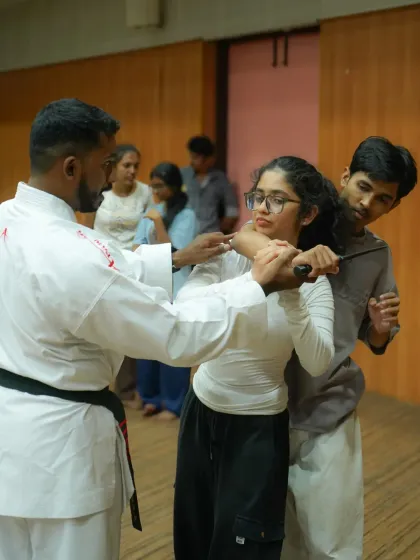 We prepare you for worst-case scenarios, including weapon-based threats. Here, an instructor demonstrates a practical technique to defend against a knife attack, focusing on control, disarming, and creating distance.