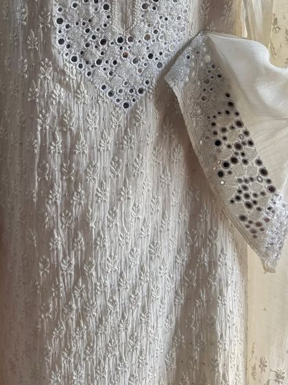 A detail shot of the sleeve and side panel, showing the intricate placement of mirrors.