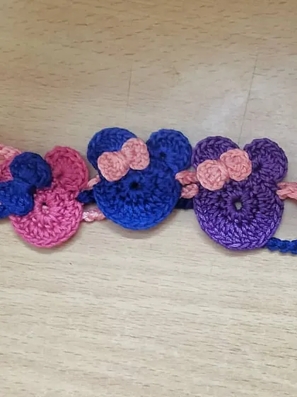 A set of colorful Minnie Mouse inspired rakhis for kids. Featuring the iconic ears and bow, these are perfect for siblings who love cartoons and Disney.