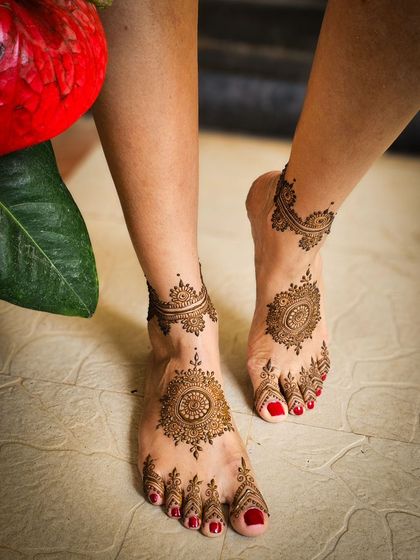 A beautiful shot of mandala foot henna, with fresh flowers in the background.