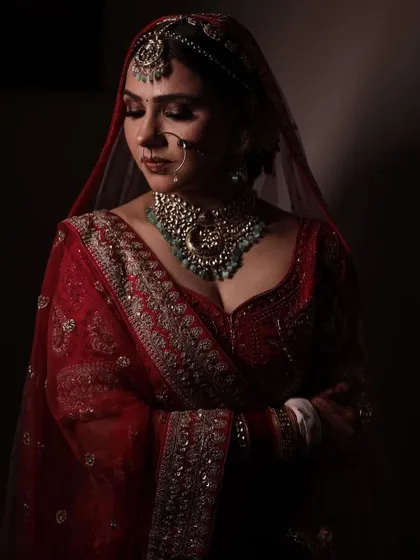 A quiet, reflective moment. The dramatic lighting highlights her beautiful features and the intricate jewellery.