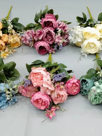 Colorful artificial peony bunches in yellow, blue, pink, and green, offering a wide palette for decorators.