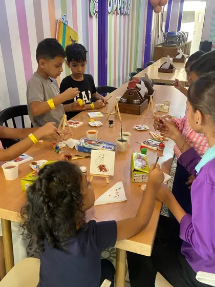 Another view of our art room, where kids are busy painting on mini canvases with easels, just like real artists.