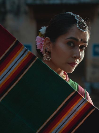 A moody, artistic shot from a heritage project. The makeup here is subtle yet effective, enhancing the dancer's features in the soft, natural light and adding to the contemplative mood of the photograph.