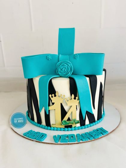 A full view of the striking zebra print and teal bow cake, perfect for a 14th birthday.
